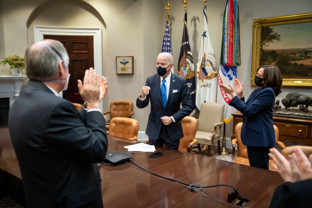 President Joe Biden and Vice President Kamala Harris, joined by White House staff, applaud as they watch the House vote on and approve the President’s COVID-19 relief bill, the American Rescue Plan Wednesday, March 10, 2021, from the Roosevelt Room of the White House.